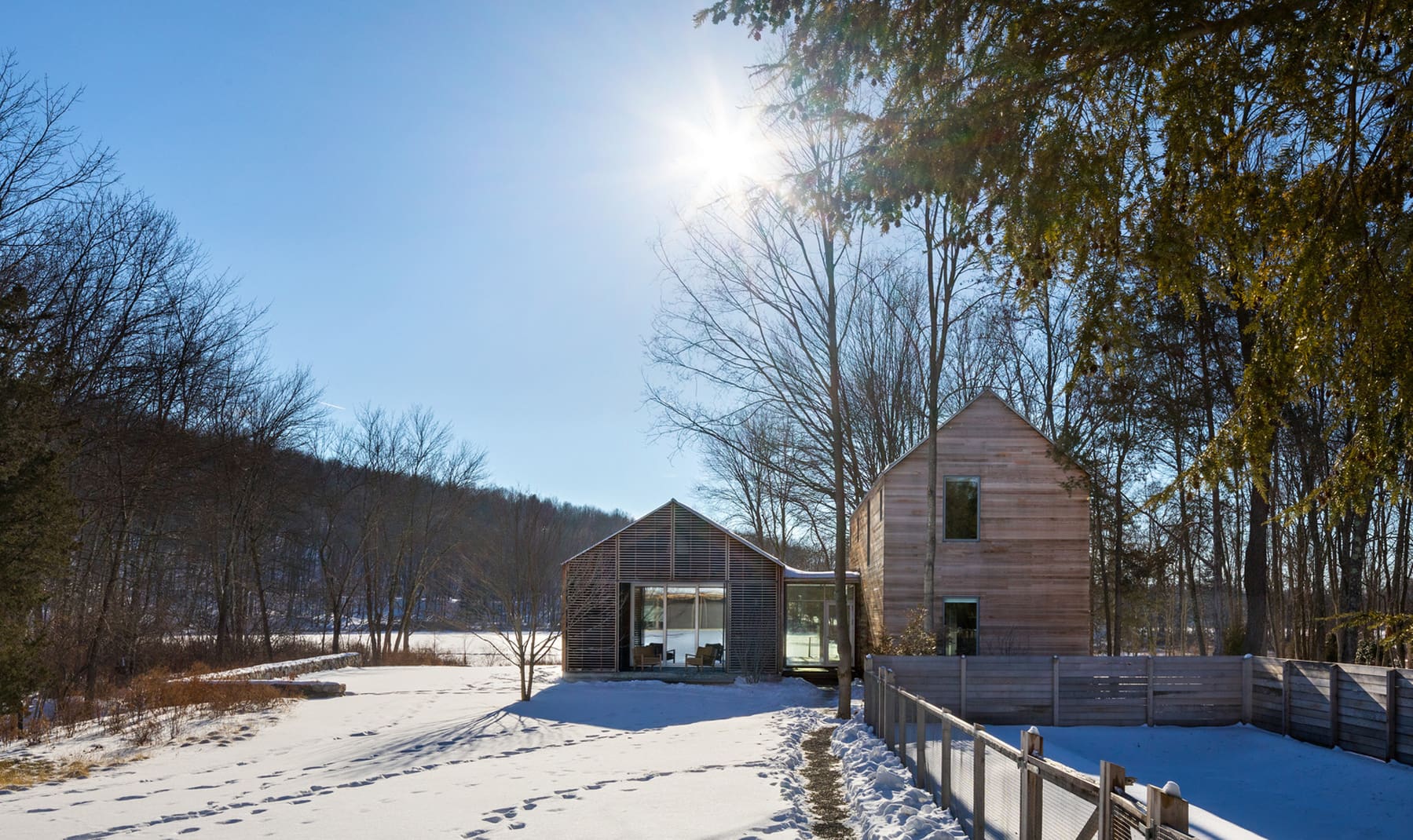An exterior of a modern OpenHome in the snow from Lake Flato