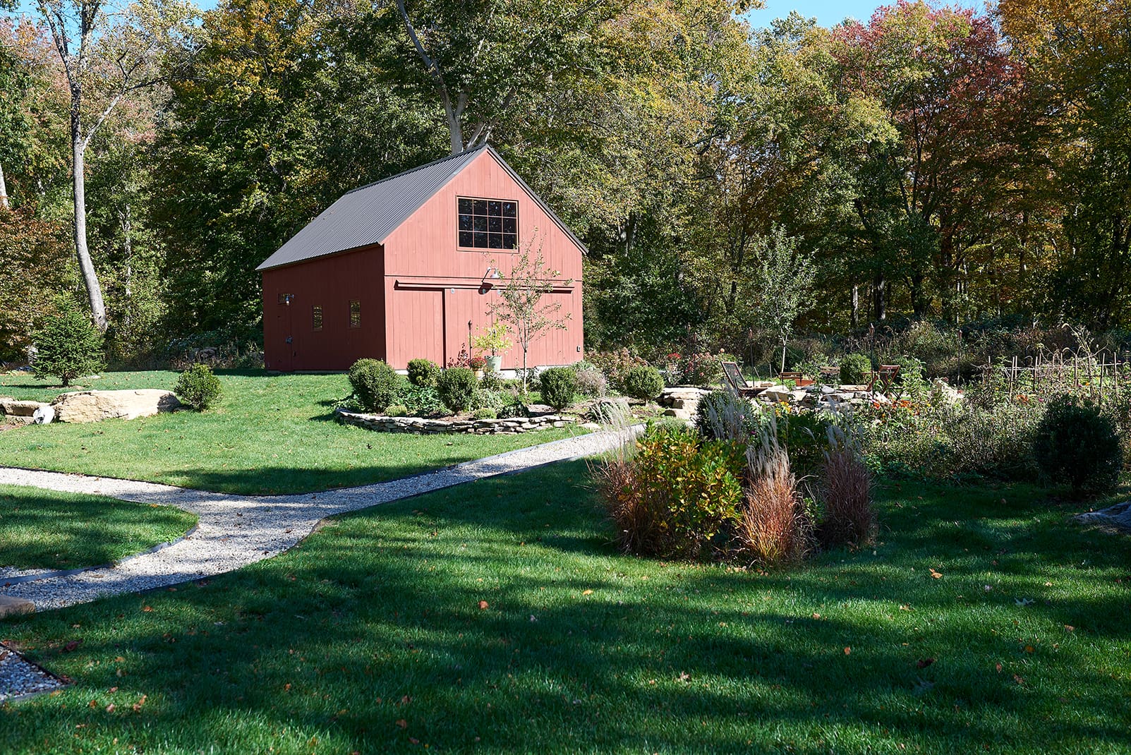 A red barn with landscaping