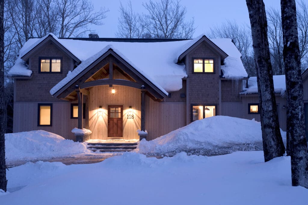 Exterior of an energy efficient home at dusk after a snow fall.