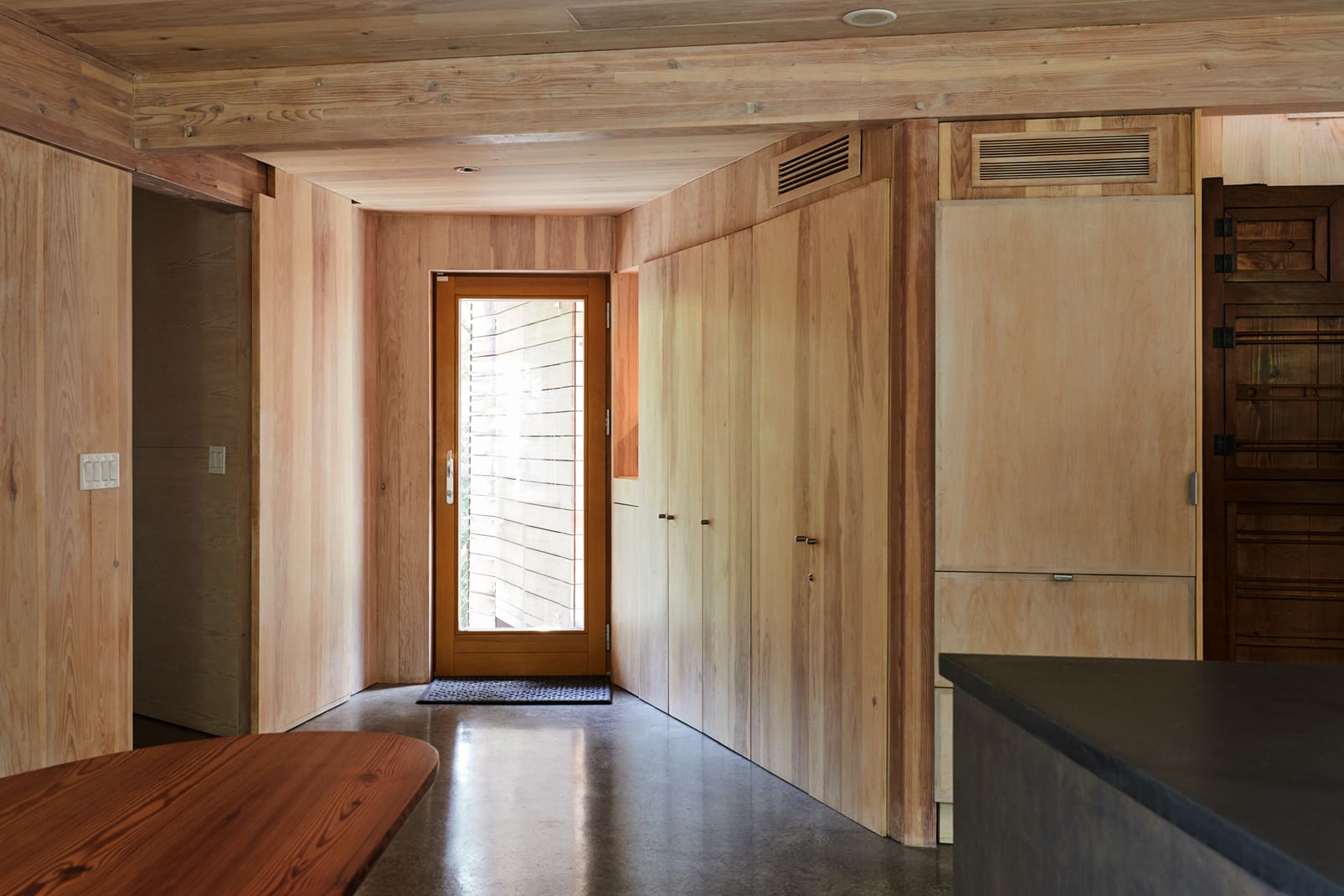 Entry way with wood paneling in a modern passive house