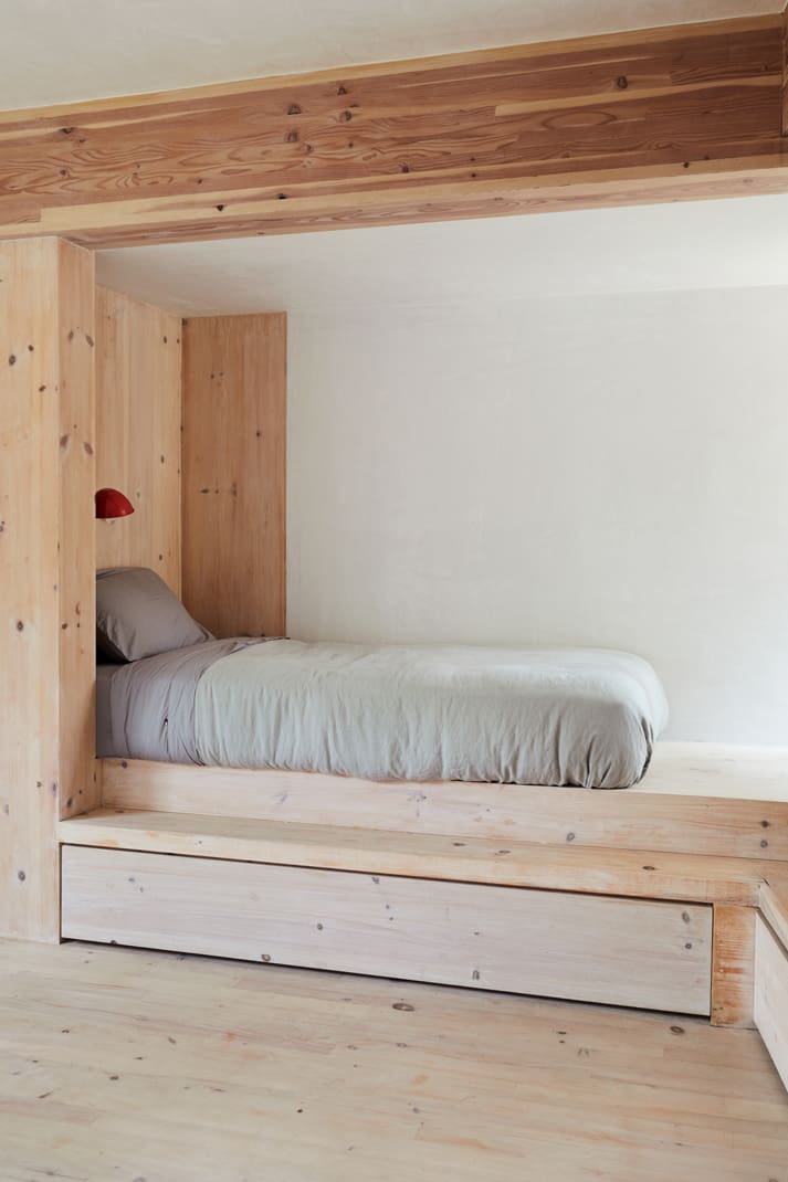 A twin bed fits into a dedicated wooden sleeping nook