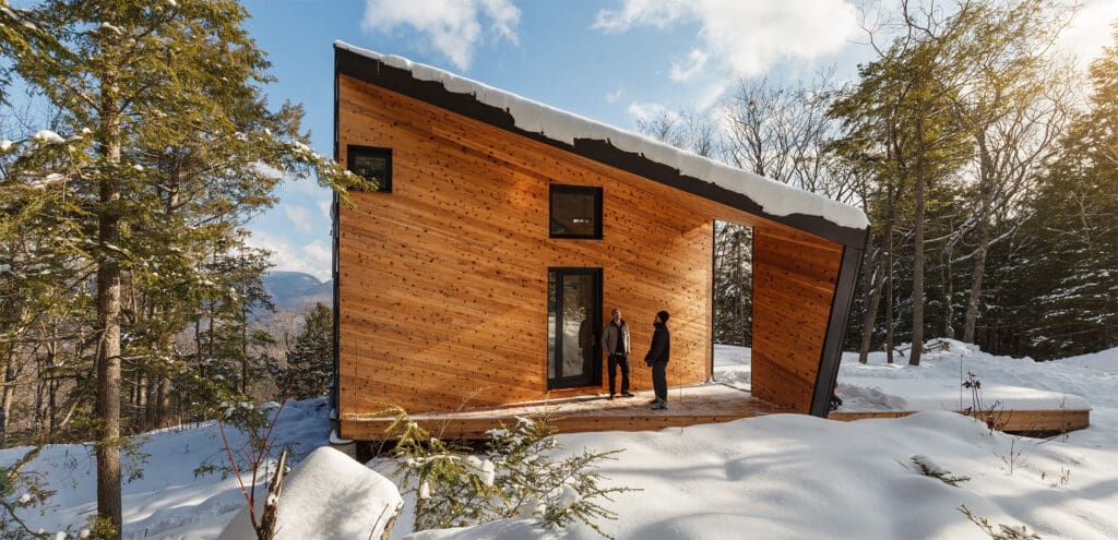 West side of a modern prefab home, showcasing its unique wood siding