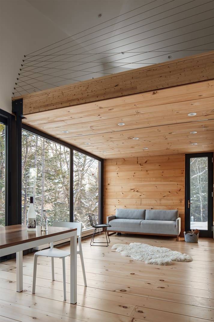 A view from the main living volume of the loft inside a modern prefab tiny house