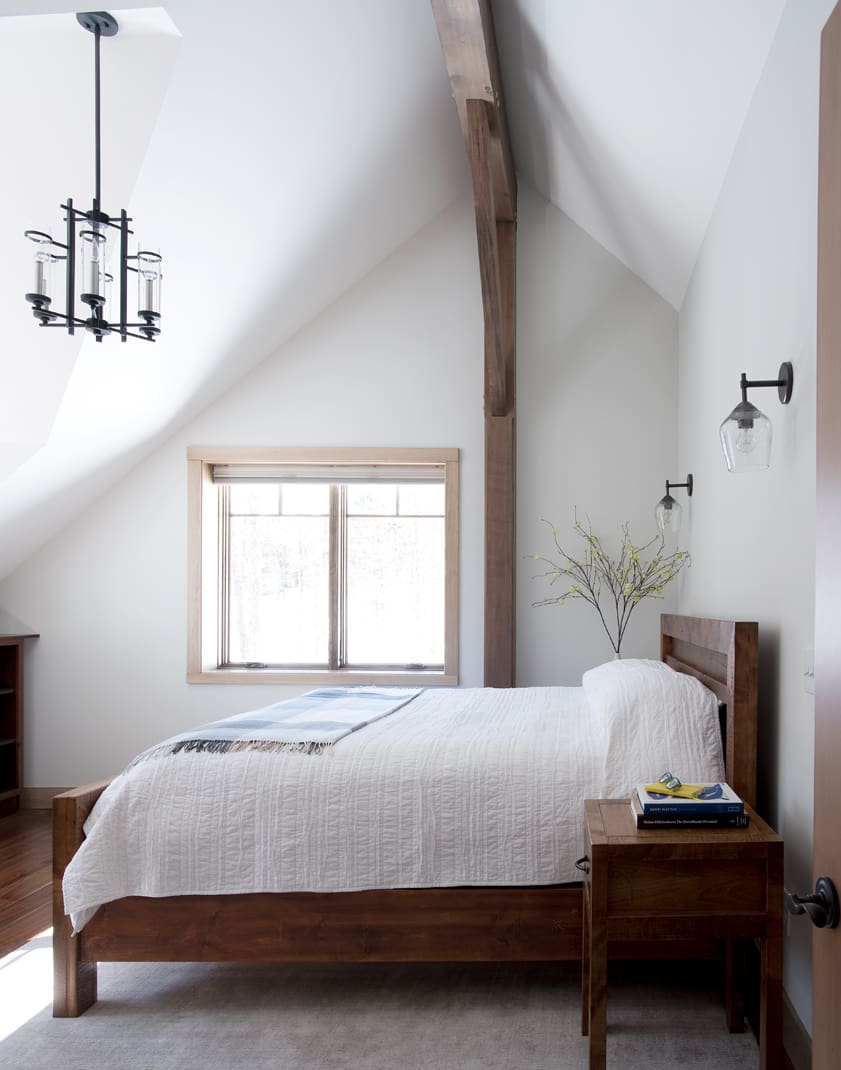A bedroom with a modern bed and timber frame detail