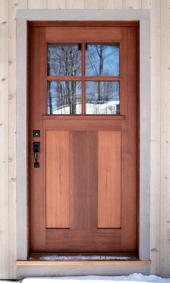 A custom mahogany door with a divided lite window