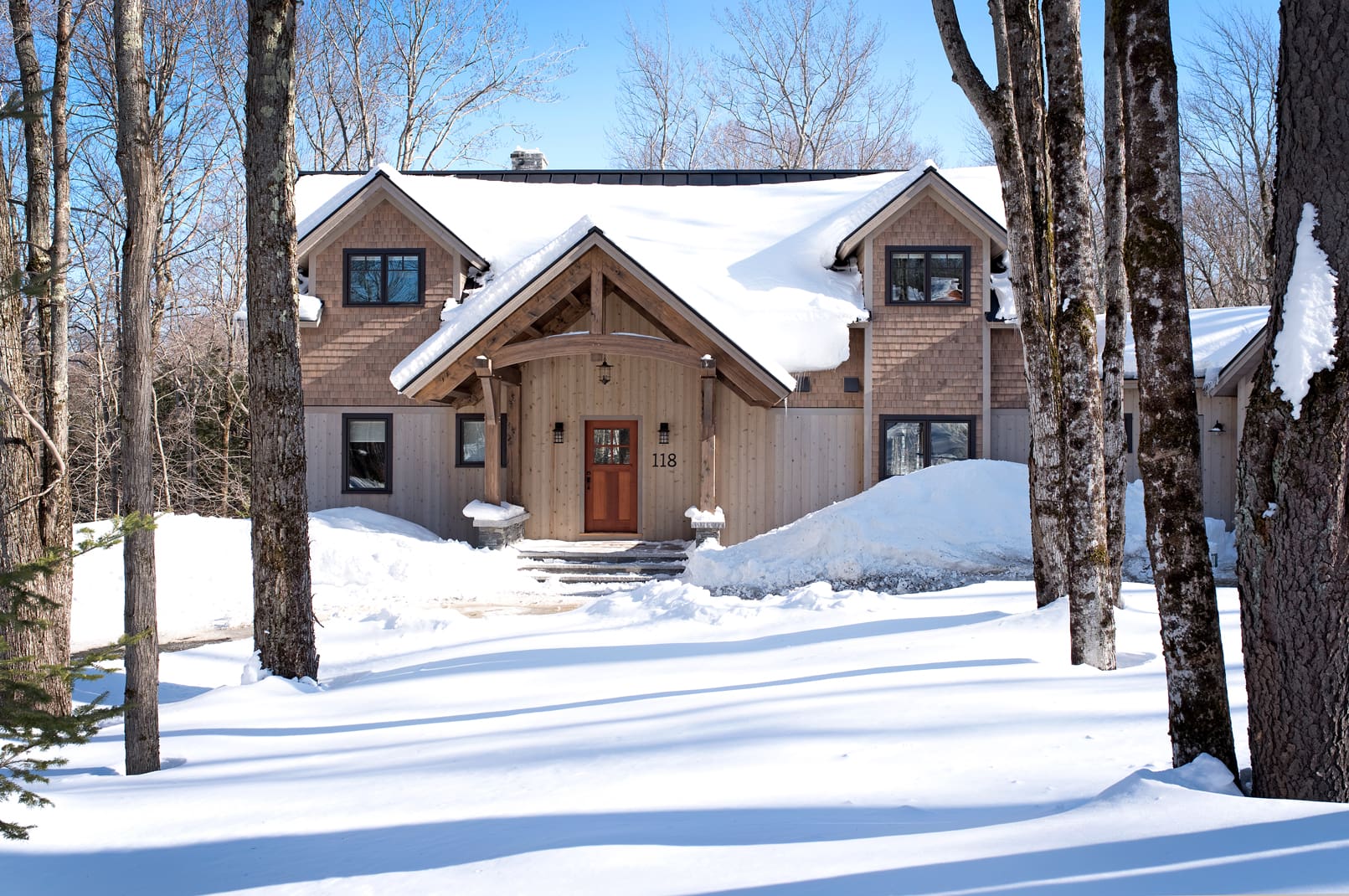 A modern craftsman style home after a snowfall