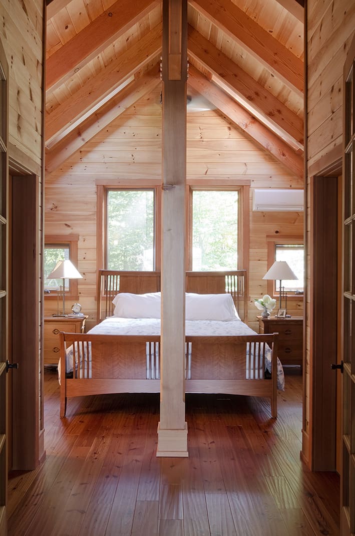 Upstairs bedroom with wood paneled walls
