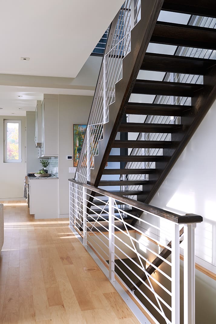 Stair case looking towards the kitchen in a Bensonwood home
