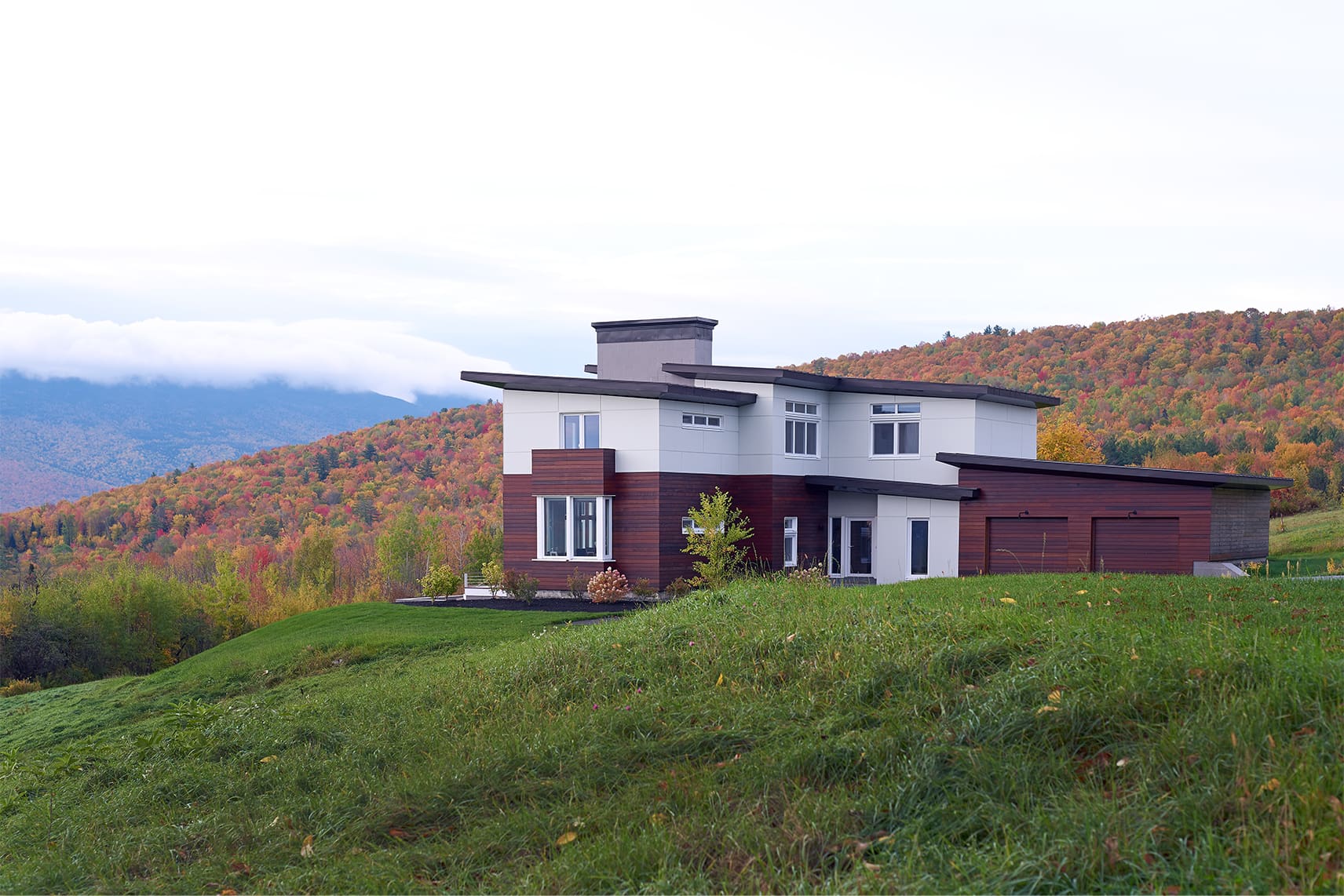 A modern Bensonwood home with a view of fall foliage