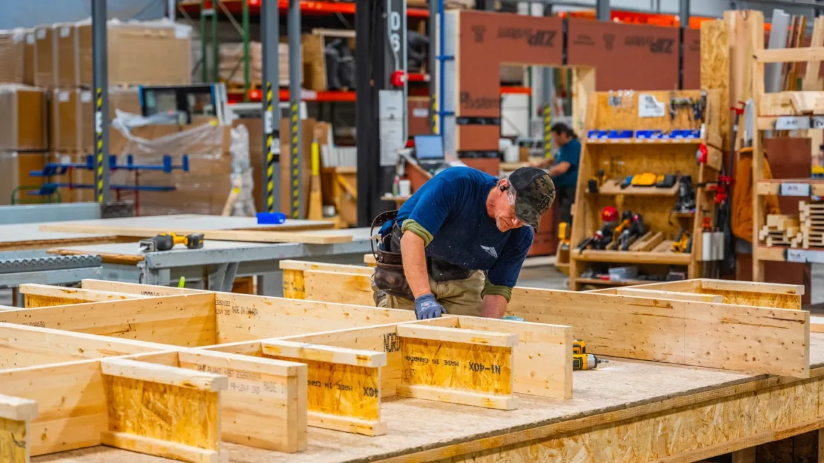 Bensonwood team member constructing a high-performance wall system in the Walpole, New Hampshire facility