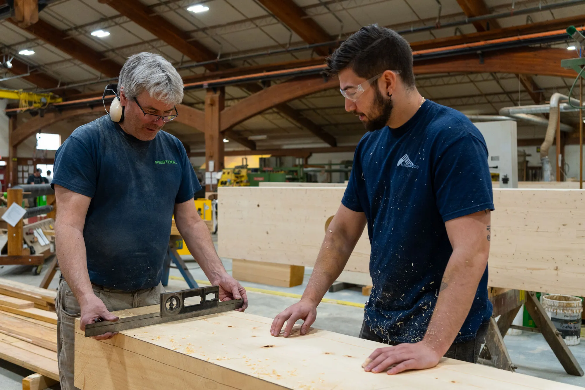 Bensonwood team sorting and measuring materials for a new home.